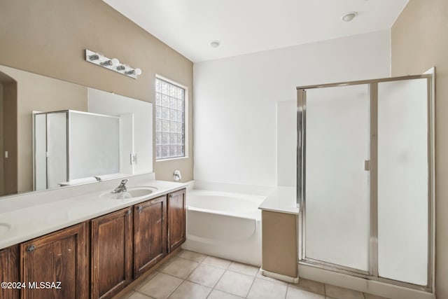 bathroom with tile patterned flooring, vanity, and separate shower and tub