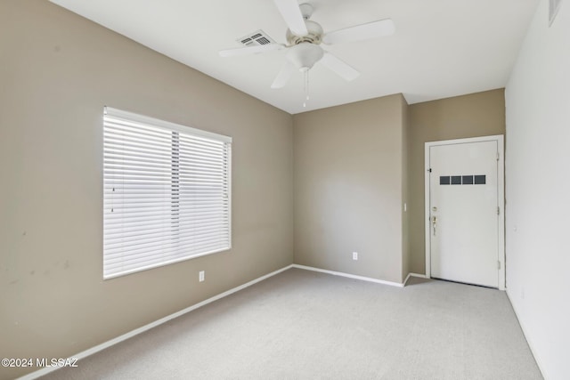 unfurnished room featuring ceiling fan and light carpet