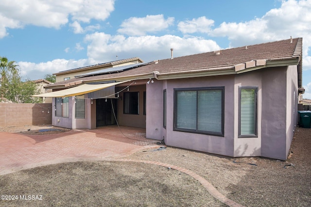 back of property featuring a patio
