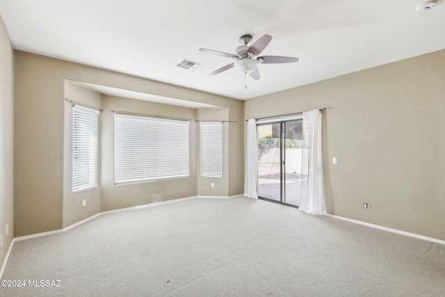 unfurnished room with ceiling fan and light colored carpet