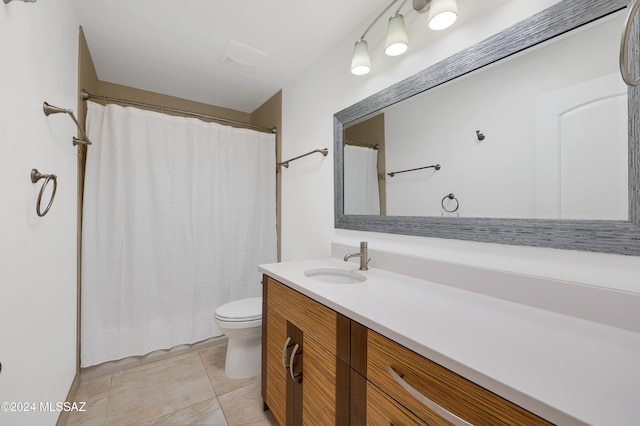 bathroom featuring tile patterned floors, vanity, and toilet