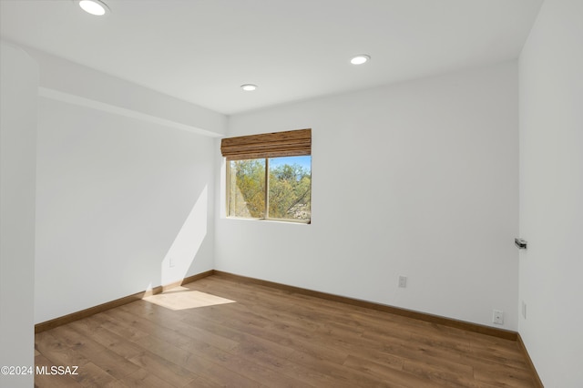 empty room with hardwood / wood-style flooring