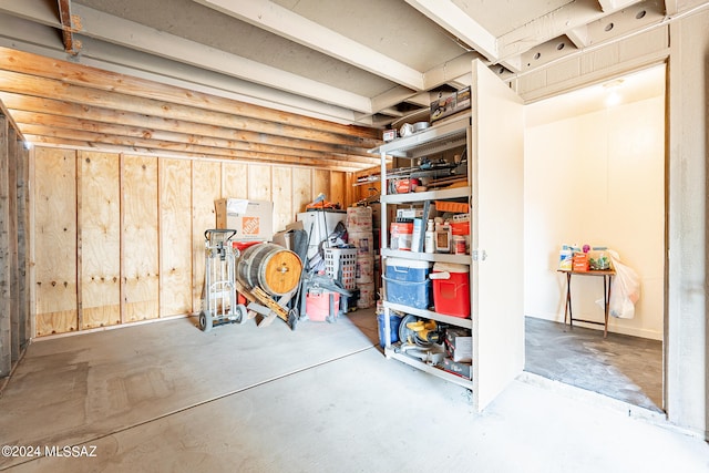 basement featuring wooden walls