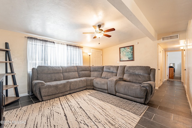 tiled living room featuring ceiling fan and beamed ceiling