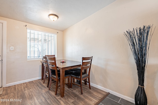 dining space featuring dark wood-type flooring