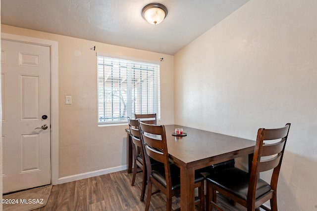 dining area featuring dark hardwood / wood-style floors