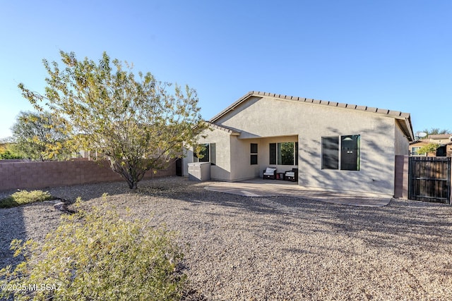 back of property featuring a patio