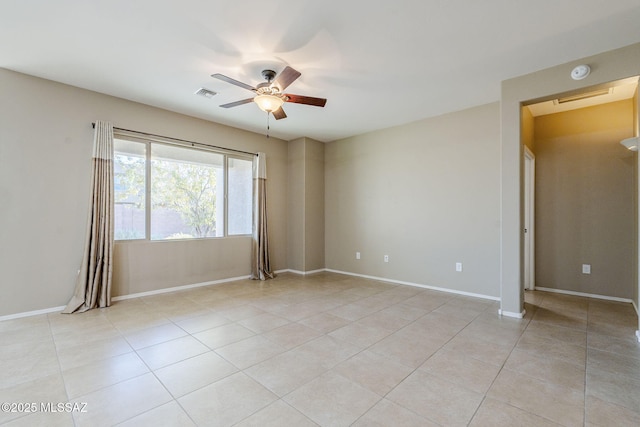 tiled spare room with ceiling fan