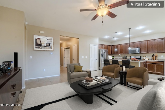 tiled living room with ceiling fan and sink