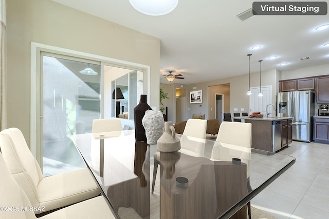 dining room featuring ceiling fan and sink