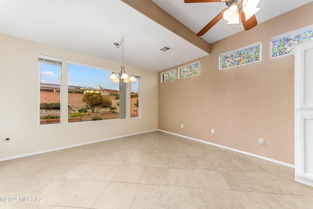 empty room featuring beamed ceiling, ceiling fan with notable chandelier, and light tile patterned flooring