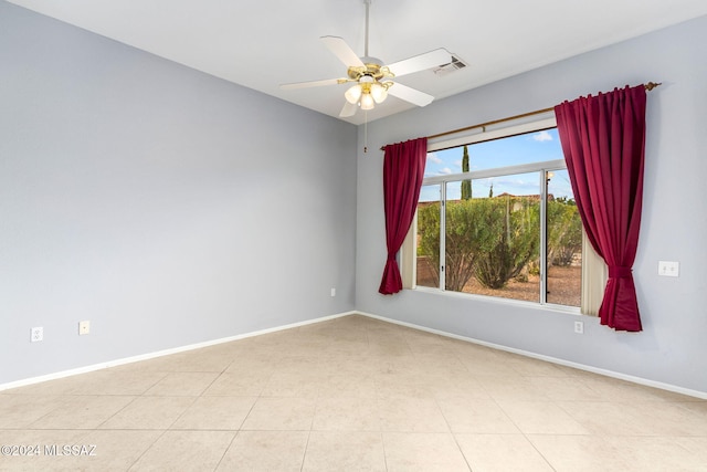 unfurnished room with light tile patterned floors and ceiling fan