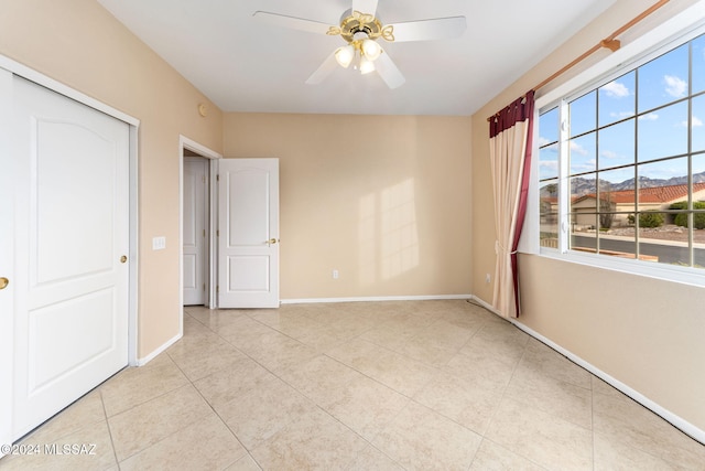 unfurnished bedroom with a closet, ceiling fan, and light tile patterned flooring