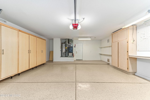 garage with water heater and a garage door opener