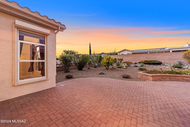 view of patio terrace at dusk