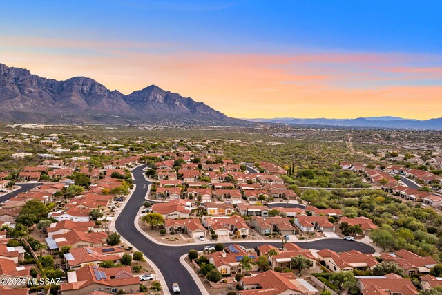 aerial view at dusk featuring a mountain view