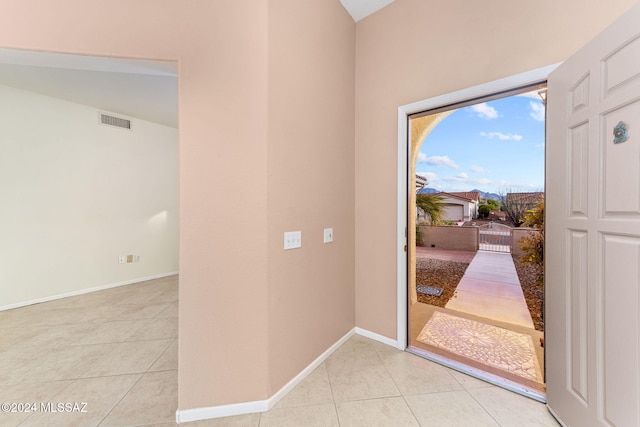 doorway with light tile patterned floors