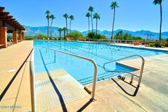 view of swimming pool with a mountain view