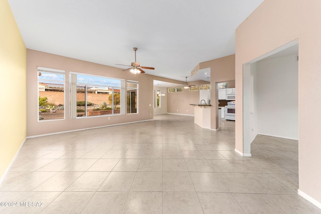 unfurnished living room with ceiling fan and light tile patterned floors