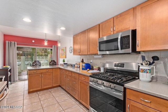 kitchen with kitchen peninsula, hanging light fixtures, stainless steel appliances, light tile patterned flooring, and tasteful backsplash