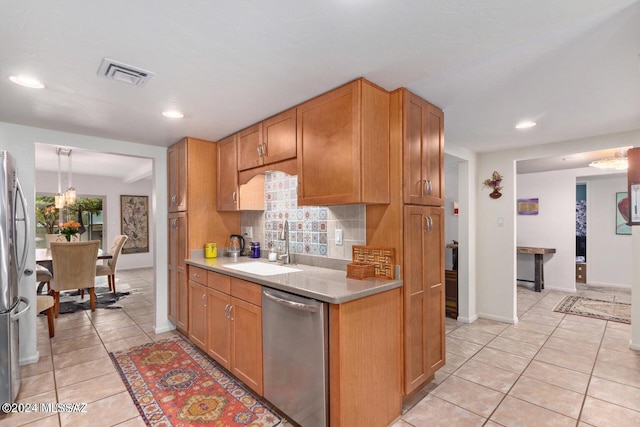 kitchen with sink, stainless steel appliances, decorative light fixtures, decorative backsplash, and light tile patterned floors