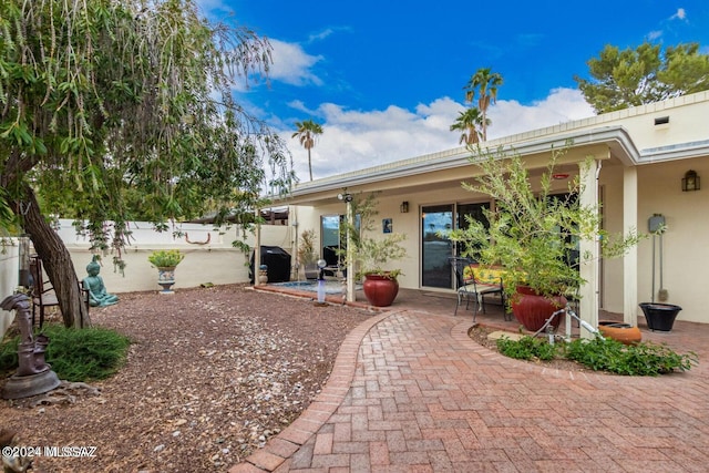 back of house with a patio