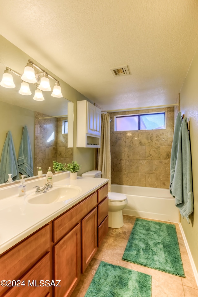 full bathroom with toilet, tile patterned flooring, vanity, a textured ceiling, and shower / bathtub combination with curtain