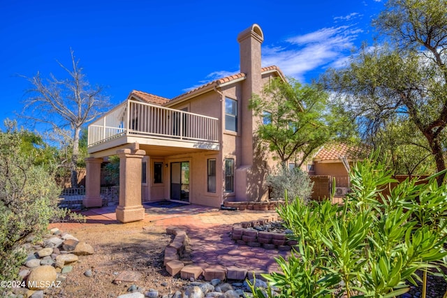 10081 N Pitchingwedge Ln, Tucson, AZ 85737 - back of house with a tile roof, a balcony, stucco siding, a patio, and fence