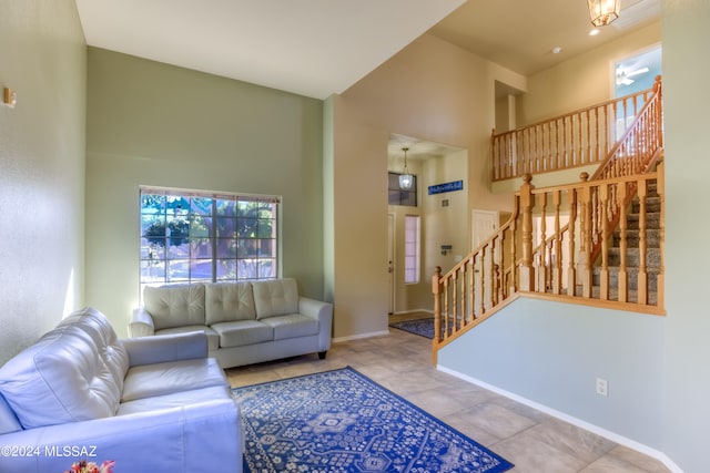 living room featuring a high ceiling and light tile patterned floors