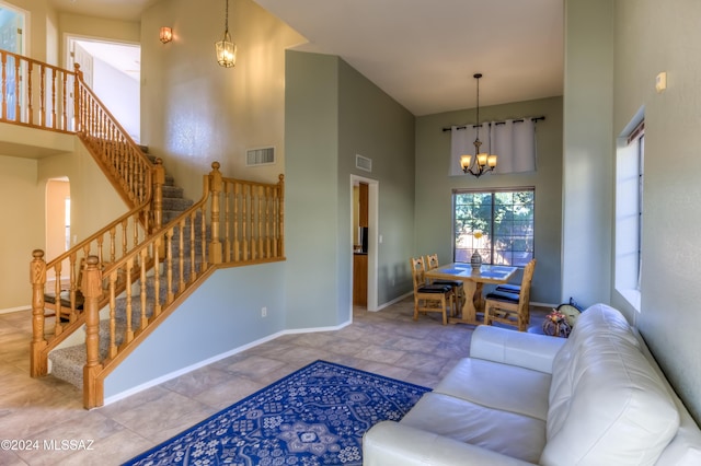 10081 N Pitchingwedge Ln, Tucson, AZ 85737 - living room with a towering ceiling, a chandelier, stairway, and baseboards