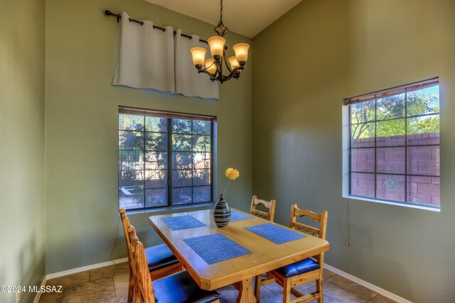 10081 N Pitchingwedge Ln, Tucson, AZ 85737 - dining room featuring a chandelier, healthy amount of natural light, baseboards, and a high ceiling