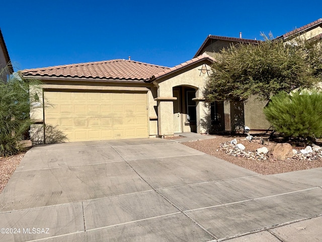 mediterranean / spanish-style home with a garage