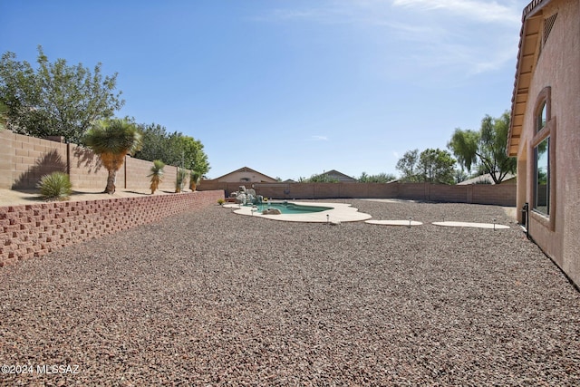 view of yard featuring a patio and a fenced in pool