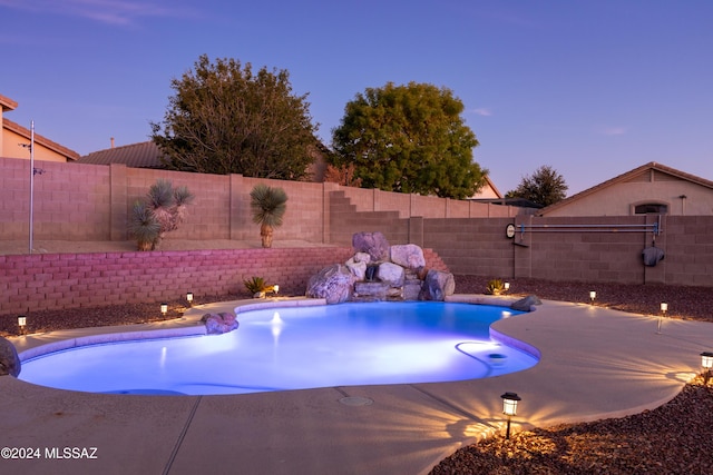 view of pool at dusk