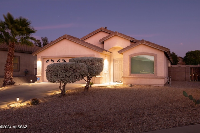 mediterranean / spanish home with a garage