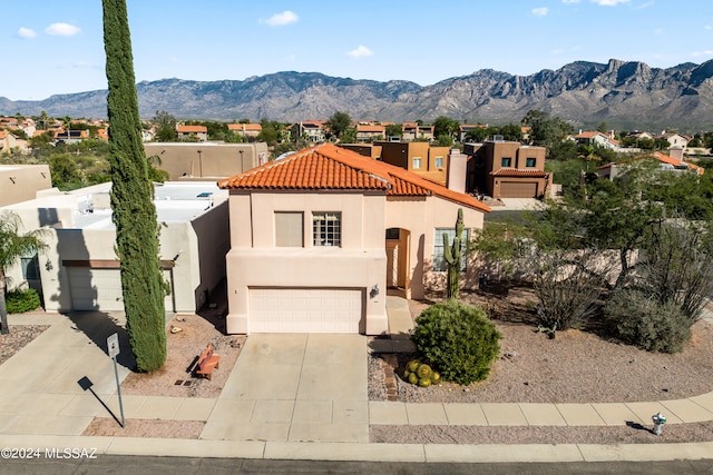 view of front of house with a mountain view and a garage