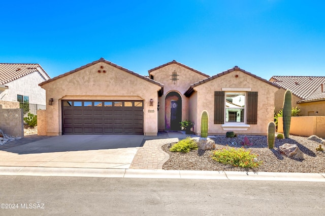 mediterranean / spanish-style house featuring a garage