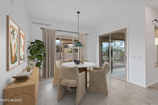 dining room featuring light tile patterned flooring and baseboards