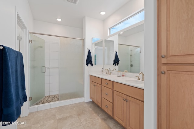 full bathroom featuring a stall shower, double vanity, tile patterned flooring, and recessed lighting