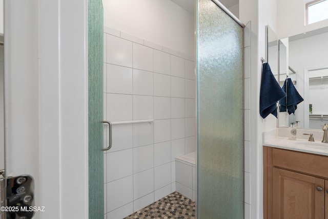 bathroom with a stall shower and vanity