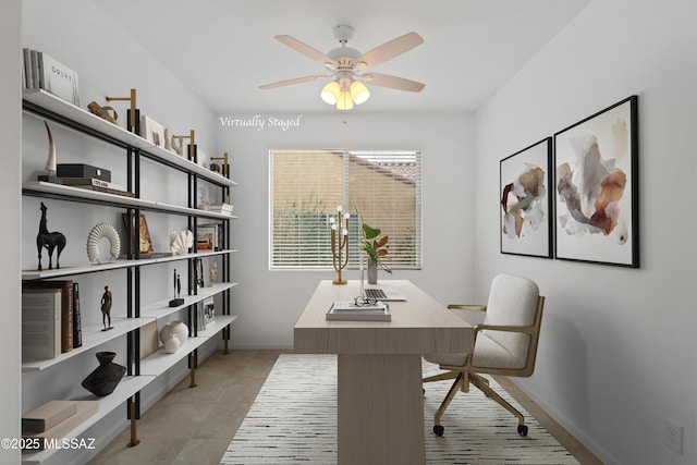 office space with ceiling fan and baseboards