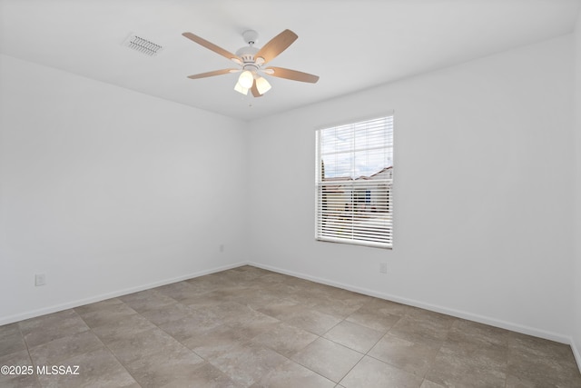 unfurnished room featuring a ceiling fan and baseboards