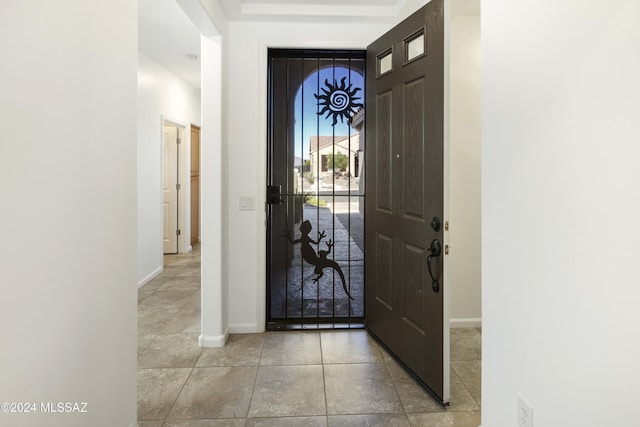 tiled entryway featuring baseboards