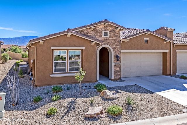 view of front of property with a mountain view and central AC