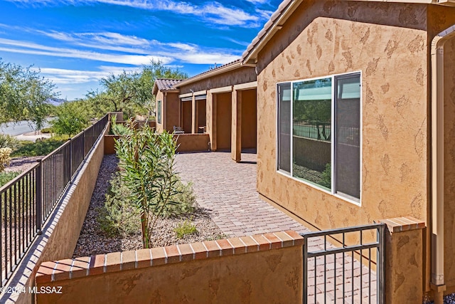 view of side of property featuring a patio area