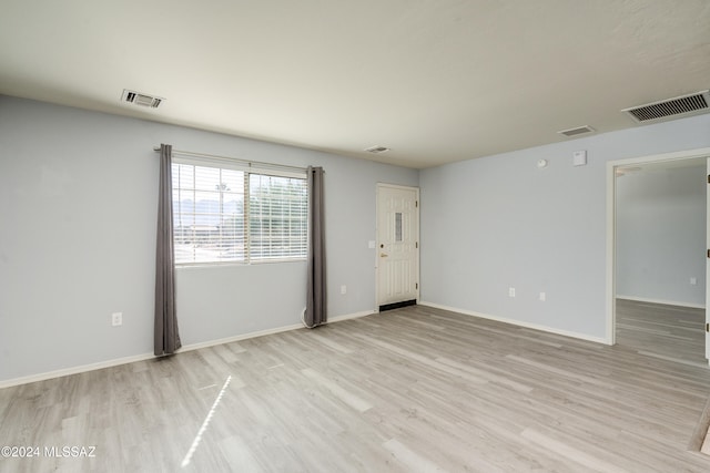 spare room with light hardwood / wood-style flooring