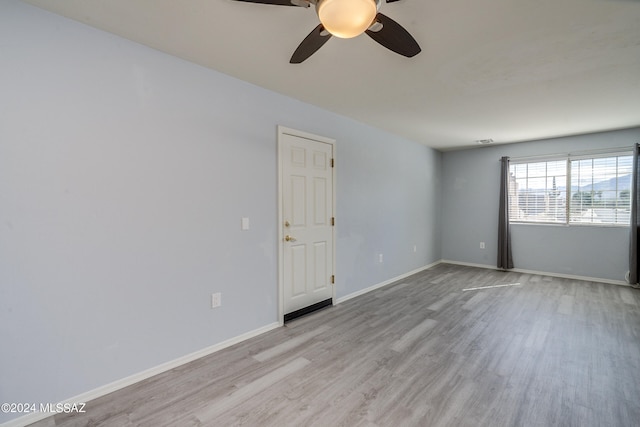 spare room featuring light hardwood / wood-style floors and ceiling fan