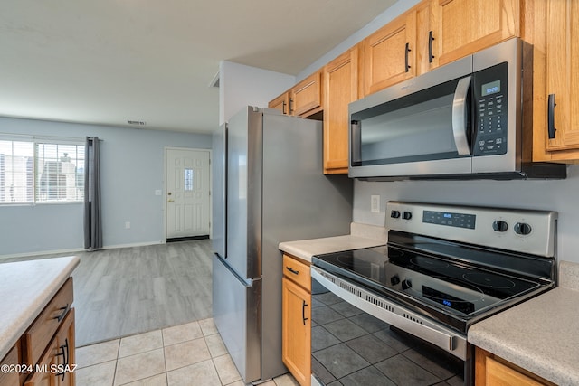 kitchen with light hardwood / wood-style floors and stainless steel appliances