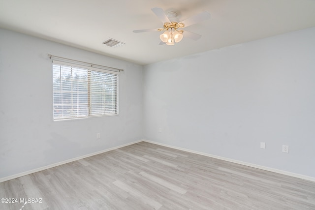 empty room with light hardwood / wood-style floors and ceiling fan