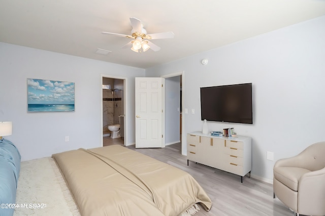 bedroom with connected bathroom, light wood-type flooring, and ceiling fan